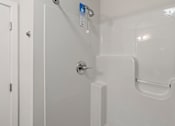 Thumbnail 36 of 56 - A white door with a handle and a white shower stall with a glass door.