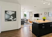 Thumbnail 41 of 56 - A modern kitchen with a black countertop and cabinets.