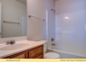 Thumbnail 15 of 35 - A white bathroom with a toilet and sink.