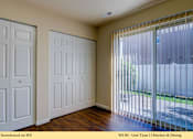 Thumbnail 4 of 35 - A kitchen and dining room with white doors and a sliding glass door.