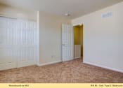 Thumbnail 11 of 35 - A room with a carpeted floor and a door leading to another room.