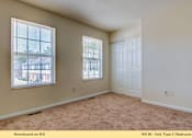 Thumbnail 5 of 35 - A bedroom with a carpeted floor and a window.