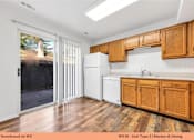 Thumbnail 18 of 35 - A kitchen with wooden cabinets and a white fridge.