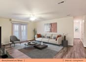 Thumbnail 9 of 31 - a living room with a couch and a table