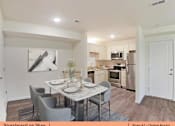 Thumbnail 3 of 31 - an open kitchen and dining room with a table and chairs
