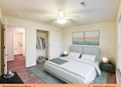 Thumbnail 5 of 31 - a bedroom with a bed and a ceiling fan and a closet