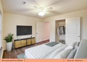 Thumbnail 10 of 31 - a bedroom with a large bed and a tv