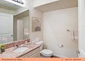 Thumbnail 4 of 31 - a bathroom with a sink toilet and a mirror