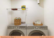 Thumbnail 11 of 31 - a laundry room with washing machines and baskets