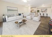 Thumbnail 16 of 31 - a living room with two couches and a table
