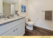 Thumbnail 14 of 31 - a bathroom with a toilet and a sink and a mirror