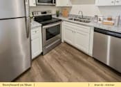 Thumbnail 13 of 31 - a kitchen with stainless steel appliances and white cabinets