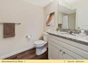 Thumbnail 21 of 31 - a bathroom with a toilet and a sink and a mirror