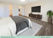 Thumbnail 24 of 31 - a bedroom with a bed and a tv on the wall