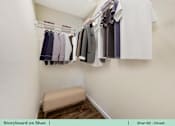 Thumbnail 30 of 31 - a walk in closet with a rack of clothes