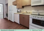 Thumbnail 4 of 30 - a kitchen with white appliances and wooden floors