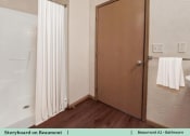 Thumbnail 6 of 30 - a bathroom with a shower and a shower curtain
