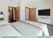 Thumbnail 5 of 30 - a bedroom with a bed and a tv on the wall