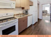 Thumbnail 11 of 30 - a kitchen with white appliances and wooden floors