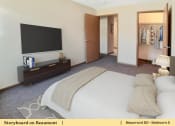 Thumbnail 27 of 30 - a bedroom with a bed and a tv in a hotel room