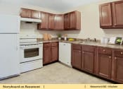 Thumbnail 19 of 30 - a kitchen with white appliances and brown cabinets