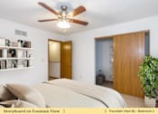 Thumbnail 12 of 27 - a bedroom with a bed and a ceiling fan