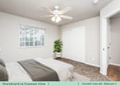 Thumbnail 22 of 27 - a bedroom with a bed and a ceiling fan