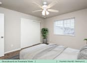 Thumbnail 25 of 27 - a bedroom with a bed and a ceiling fan