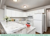 Thumbnail 18 of 27 - a kitchen with white cabinets and a marble counter top