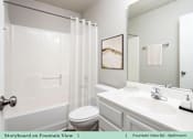 Thumbnail 21 of 27 - a white bathroom with a sink toilet and shower