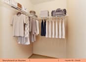 Thumbnail 9 of 17 - a walk in closet with a rack of clothes and a closet organizer