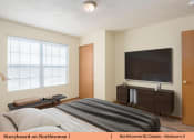 Thumbnail 12 of 29 - a bedroom with a bed and a television