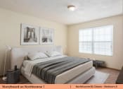 Thumbnail 15 of 29 - a bedroom with a bed and a large window