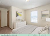 Thumbnail 21 of 29 - a bedroom with a white bed and a white dresser