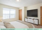 Thumbnail 25 of 29 - a bedroom with a bed and a tv
