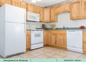 Thumbnail 16 of 30 - a kitchen with white appliances and wooden cabinets