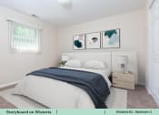 Thumbnail 19 of 30 - a white bedroom with a bed and three pictures on the wall