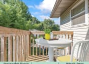 Thumbnail 15 of 30 - a patio with a table and chairs on a balcony