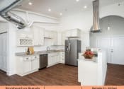 Thumbnail 51 of 58 - a kitchen with white cabinets and stainless steel appliances