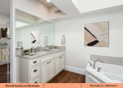 Thumbnail 57 of 58 - a bathroom with two sinks and a tub and a mirror