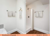 Thumbnail 58 of 58 - a bathroom with white towels and a shower and a toilet