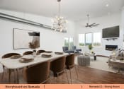 Thumbnail 48 of 58 - a dining room and living room with a table and chairs
