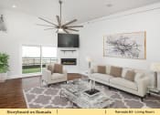 Thumbnail 44 of 58 - a living room with a couch and a ceiling fan