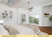 Thumbnail 43 of 58 - a bedroom with a bed and a ceiling fan