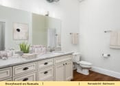 Thumbnail 37 of 58 - a bathroom with a sink and a toilet and a mirror
