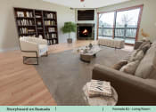 Thumbnail 28 of 58 - a living room with a couch and a fireplace
