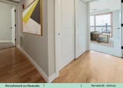 Thumbnail 34 of 58 - a view of a living room and a hallway with wood flooring and a door