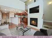 Thumbnail 18 of 58 - a living room with a fireplace  and a kitchen