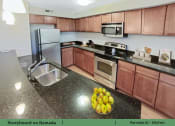 Thumbnail 6 of 58 - a kitchen with granite counter tops and stainless steel appliances