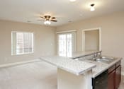 Thumbnail 13 of 23 - A kitchen with a countertop and a fan.